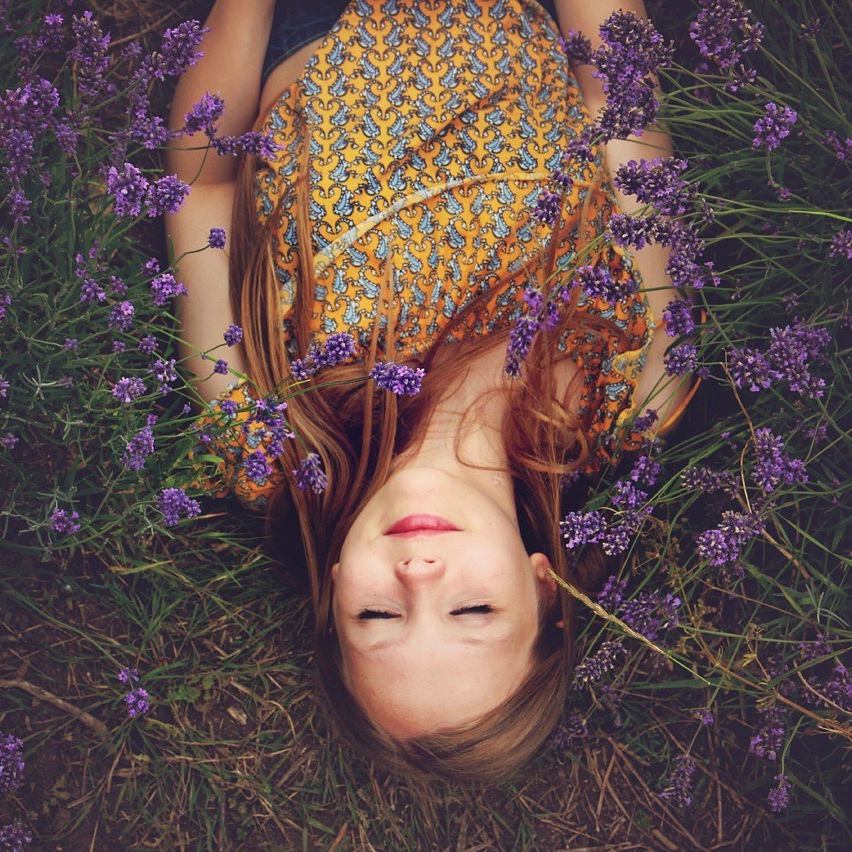 Girl lay down on grass with lavender